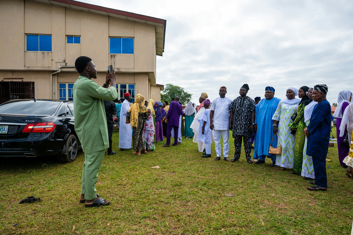 Outdoor gathering with a man addressing a group.